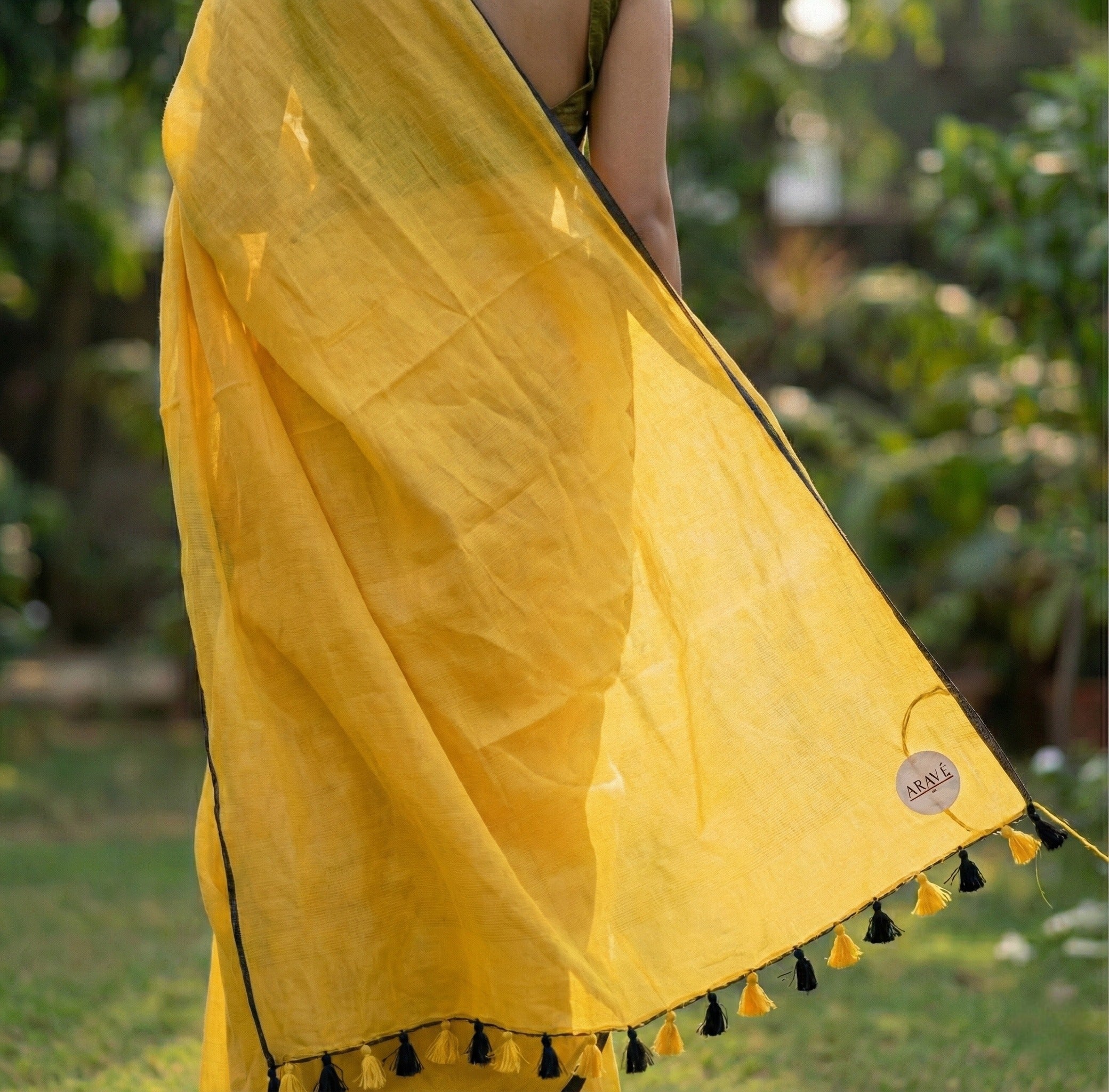 Sunehri Tale - Mango Yellow Mulmul Saree with Thin Black Border and Yellow–Black Tassels