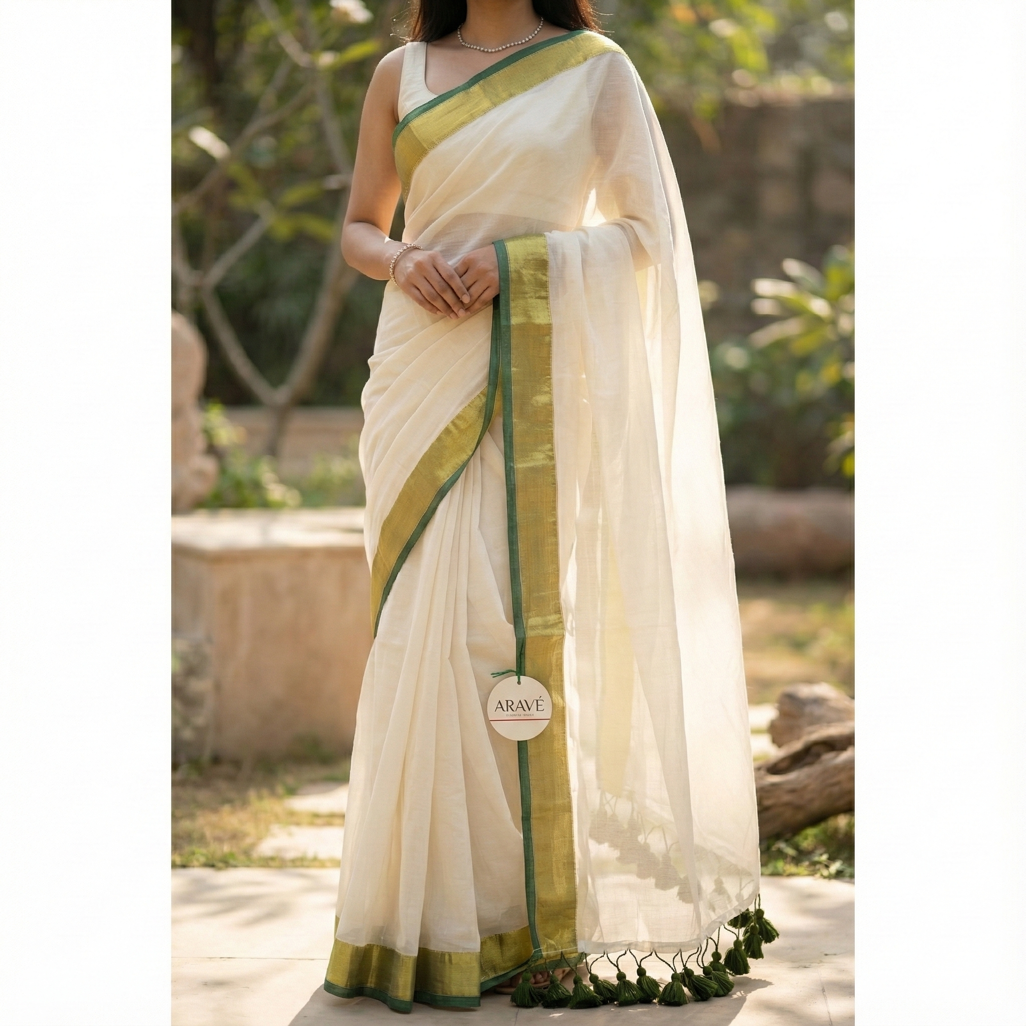 Shwet Adaa - White Mulmul Saree with Golden–Green Border and Green Tassels