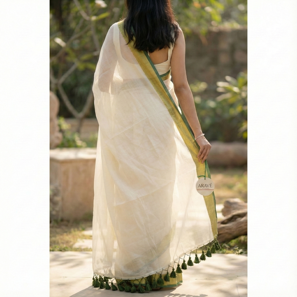 Shwet Adaa - White Mulmul Saree with Golden–Green Border and Green Tassels