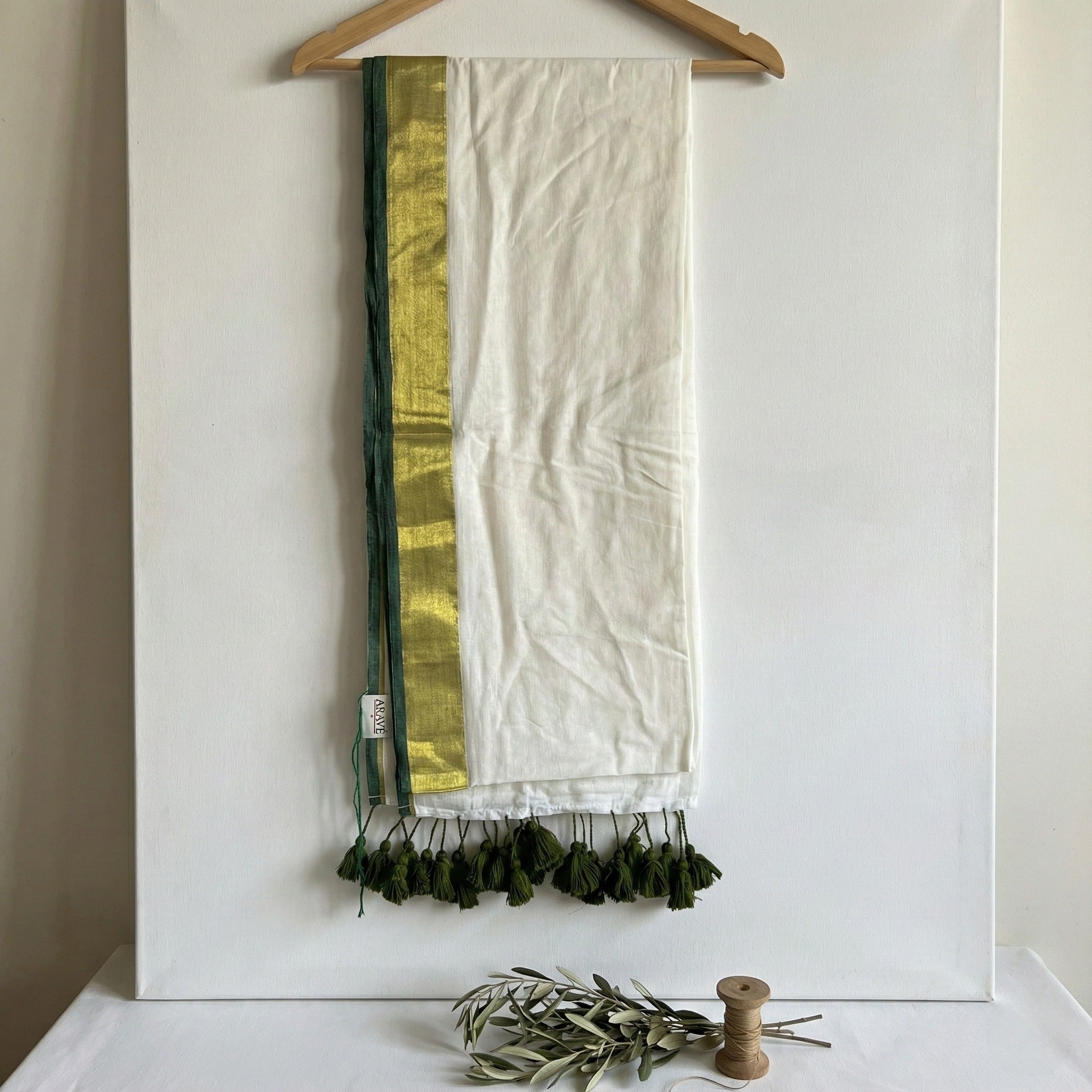 Shwet Adaa - White Mulmul Saree with Golden–Green Border and Green Tassels