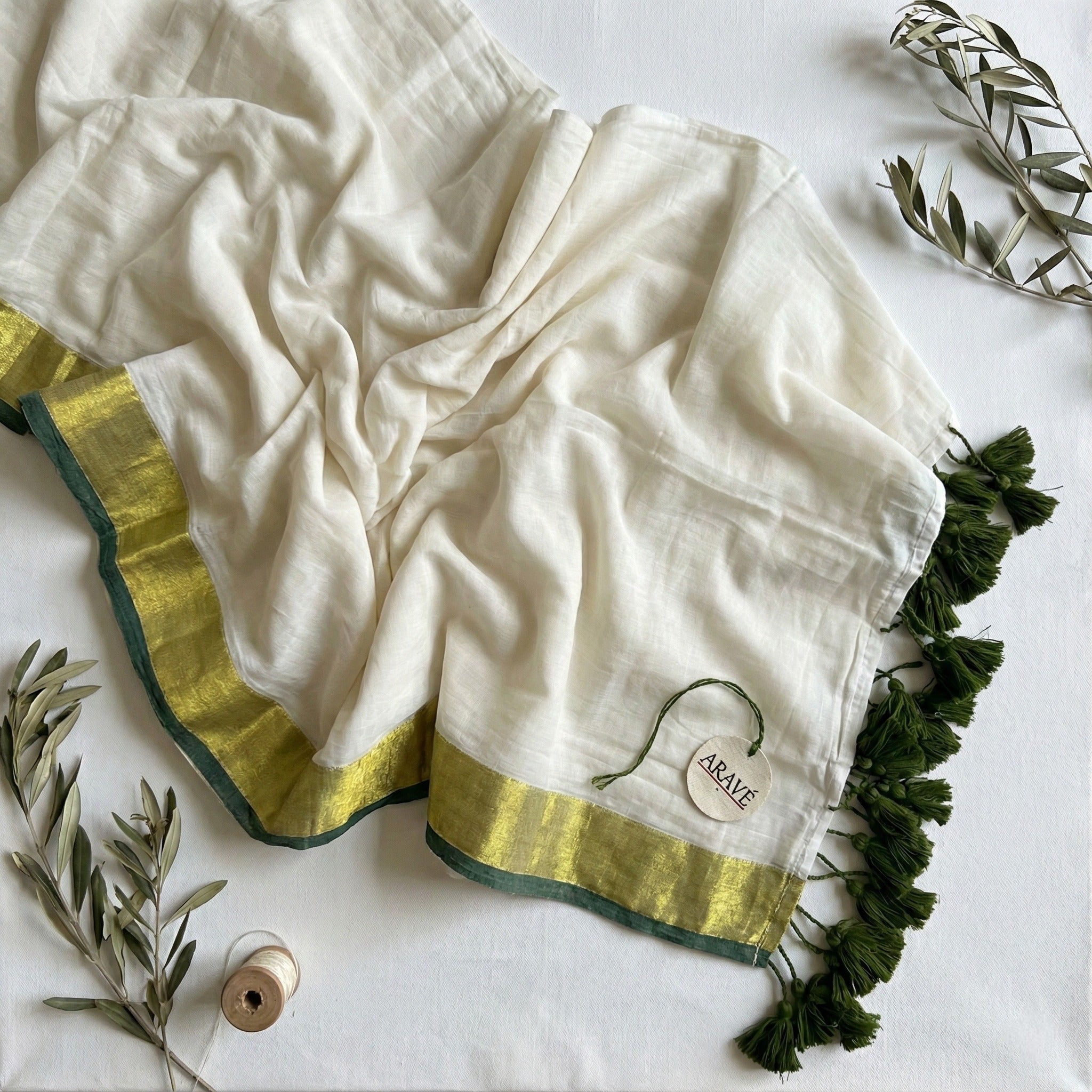 Shwet Adaa - White Mulmul Saree with Golden–Green Border and Green Tassels